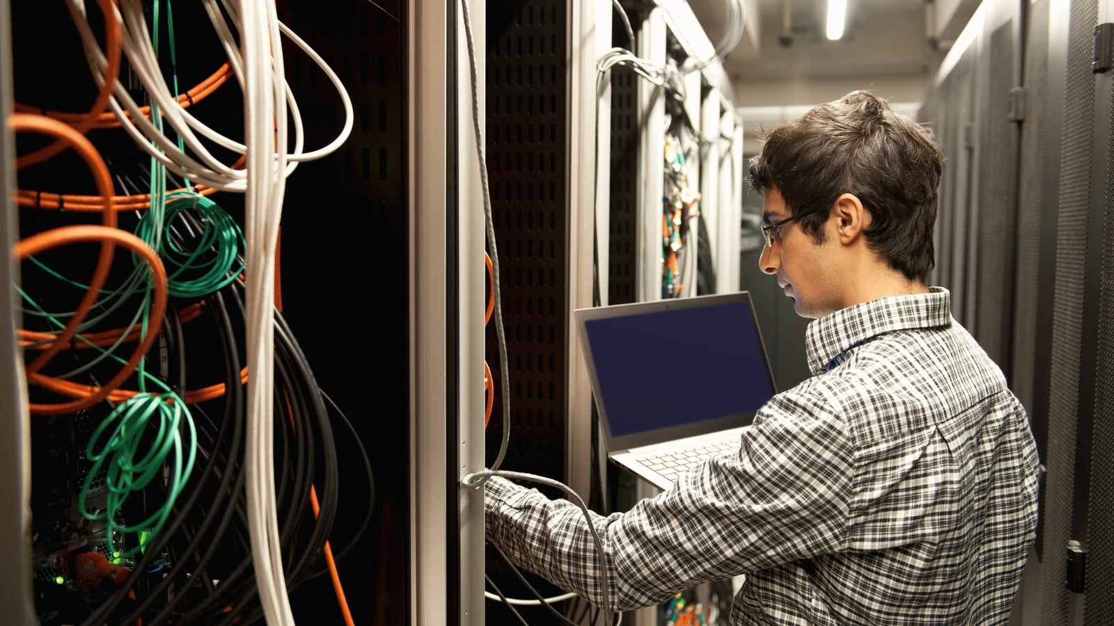 A technician working on a server with a laptop
